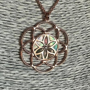 Seed of Life in rose gold on 925 silver, black mother of pearl background, sacred geometry spiritual jewel, necklace and pendant