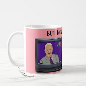 Può includere: Tazza in ceramica bianca con sfondo rosa. L'immagine presenta un cartone animato di un uomo su uno schermo televisivo. Lo schermo mostra un uomo in giacca e cravatta. Le parole "BUT NOW" sono stampate sulla tazza.