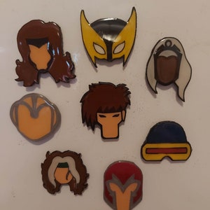 May include: A set of eight enamel pins featuring characters from the X-Men comic book series. The pins are colourful and feature the characters' iconic costumes and hairstyles. The characters include Wolverine, Storm, Cyclops, Jean Grey, Rogue, Gambit, and Magneto.