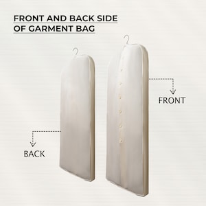 May include: Front and back view of a garment bag. The bag is white with a zipper closure and a hanger loop. The bag is designed to protect clothing from dust and wrinkles.
