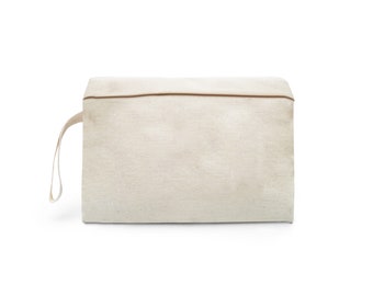 May include: A plain white canvas zippered pouch with a brown zipper and a single brown strap.