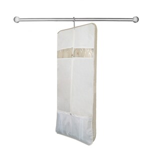 May include: A white garment bag with a clear plastic window and a zipper closure. The bag is hanging from a silver rod.