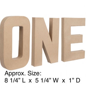 May include: Three-dimensional freestanding letters spelling the word ONE in a light tan, matte, paper-mache finish. Each letter measures approximately 8 1/4 inches long, 5 1/4 inches wide, and 1 inch deep, as indicated by the printed text below.
