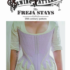 May include: A close-up of a lavender-colored corset with white piping and a row of metal boning down the center. The corset is worn by a person and has a pointed, scalloped bottom.
