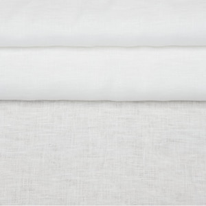 May include: Two pieces of white fabric, one smooth and one textured, are layered on top of each other. The smooth fabric is folded over the textured fabric.