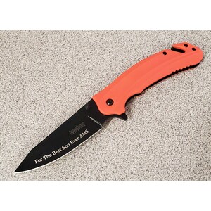 May include: A black folding knife with an orange handle. The blade is engraved with the text "For The Best Son Ever AMS".