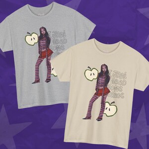 May include: Two t-shirts, one gray and one beige, each featuring a graphic of a person in a striped outfit and the text "I JUST NEED SOME SPACE." The design includes an apple graphic.