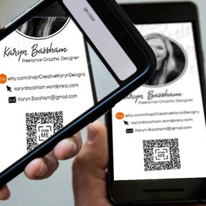 May include: A black and white business card with a QR code. The card reads "Karyn Bassham Freelance Graphic Designer" and includes contact information for Etsy, Wordpress, and email. The card is being scanned by a smartphone.