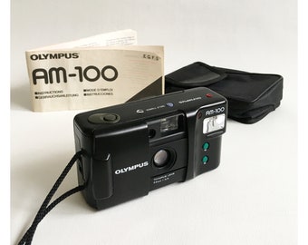 Olympus AM-100 35 mm Film Compact Camera F3.5 Lens Fully Automatic Point-and-Shoot Lightweight Instructions Case Lanyard c. 1987