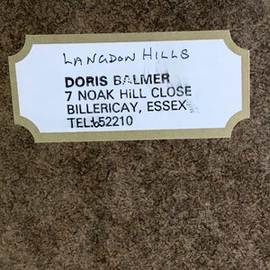May include: A white label with black text that reads "LANGDON HILLS", "DORIS BALMER", "7 NOAK HILL CLOSE", "BILLERICAY, ESSEX", and "TEL: 652210".