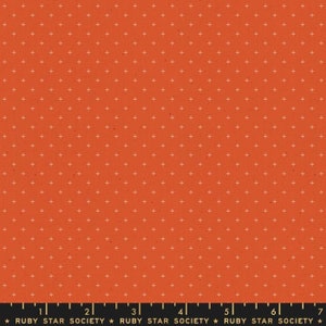 May include: A bright orange fabric with a repeating pattern of small white plus signs. The fabric has a slightly textured surface. The text "RUBY STAR SOCIETY" is printed at the bottom of the fabric.