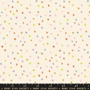May include: A white fabric with a repeating pattern of colorful stars. The stars are in various shades of pink, orange, yellow, blue, and green. The fabric is perfect for quilting, sewing, and crafting.