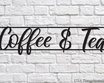 May include: Black metal sign with the words "Coffee & Tea" in a cursive font. The sign is mounted on a white brick wall.