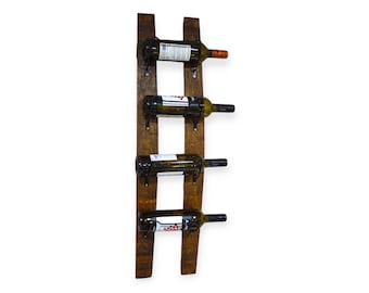 May include: A wooden wine rack made from reclaimed wine barrel staves. The rack has four metal bottle holders and is designed to be mounted on a wall.