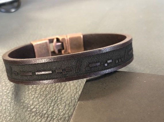 Your secret message encoded in dots and dashes on real leather — only the recipient (and Morse code nerds) will know what it says.