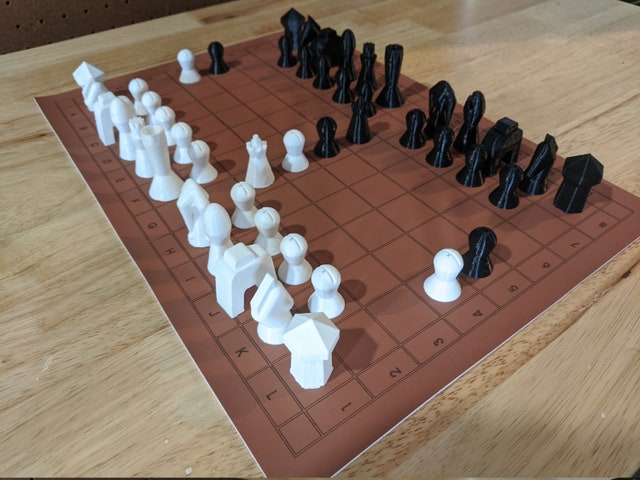 A Courier chess set in starting array on a 12x8 board