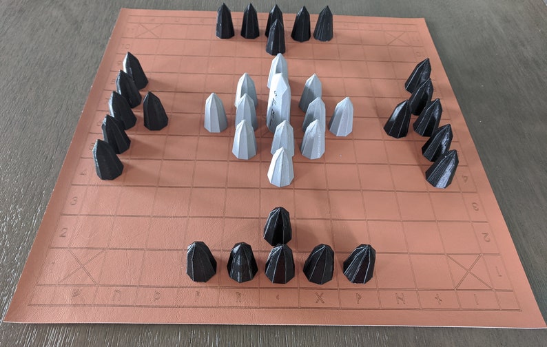 An ancient Norse Hnefatafl board set in one possible starting array on an 11x11 board