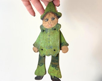 Gnomo verde de juguete de madera antiguo con brazos y piernas articulados, marioneta antigua.