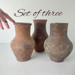 characteristic old clay vases set of three. Wabisabi vintage pottery flower jar. cozy cottage Rustic jug. antique farmhouse-style