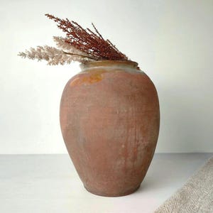 characteristic old clay vase. Wabi sabi vintage pottery flower jar. cozy cottage Rustic jug. antique farmhouse-style gift for kitchen