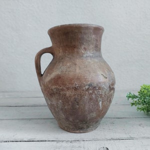 characteristic old clay vase. Wabi sabi vintage pottery flower jar. cozy cottage Rustic jug. antique farmhouse-style gift for kitchen