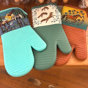 May include: A set of three ceramic mugs with a speckled, matte finish. The mugs are in shades of cream, light gray, and dark gray. Each mug has a simple, minimalist design and a rounded handle.