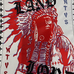 May include: A white patch with a red and blue illustration of a Native American wearing a headdress. The text "LAND" is above the illustration and "LORD" is below. The text "NTVS" is on the right side of the patch.