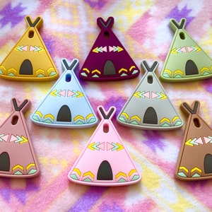 May include: Eight colorful silicone teepee-shaped teethers with geometric patterns. The teethers are in various colors, including purple, brown, pink, blue, green, and yellow.