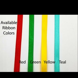 May include: Available ribbon colors: red, green, yellow, and teal. The ribbon is shown in four vertical strips.