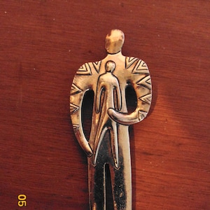signed by artist Laurel Burch lapel pin figure holding child