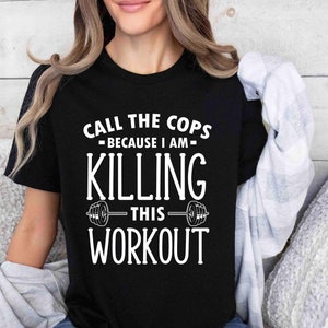 Puede incluir: Camiseta negra con texto blanco que dice "Call the Cops - Because I am - Killing This Workout" con un gráfico de barra.