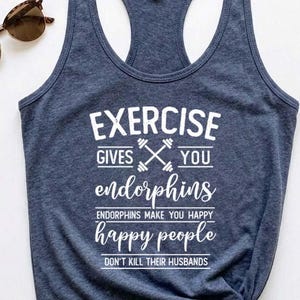 May include: Navy blue racerback tank top with white text that reads "EXERCISE GIVES YOU endorphins. Endorphins make you happy. Happy people don't kill their husbands." Tortoiseshell sunglasses are in the upper left corner.