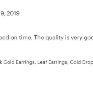 May include: A pair of gold leaf earrings. The earrings are made of 14k gold and have a delicate, natural design.