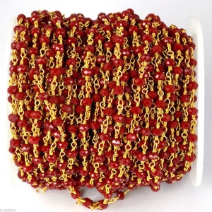 May include: A roll of red faceted beads strung on gold-coloured wire. The beads are a deep red colour and are tightly packed together. The wire is thin and delicate, creating a beautiful contrast with the bold beads. Suitable for jewellery making.