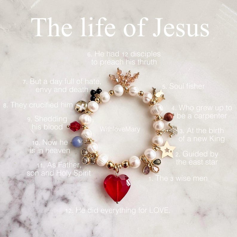 May include: A charm bracelet featuring white pearls, gold-tone metal accents, and various charms including a large red heart, a star, and a crown. Text on the image reads: The life of Jesus, WithloveMary, and numbered points 1 through 12 describing religious themes.
