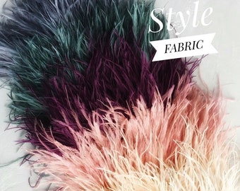 May include: Close-up of colorful fabric with a feathery texture. The fabric transitions from teal to deep purple, then to shades of pink and cream. The word "Style" is above the word "FABRIC" in a white banner.