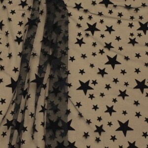 May include: Black sheer fabric with a pattern of black velvet stars of different sizes.