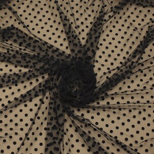 May include: Black sheer fabric with black polka dots. The fabric is textured and has a soft, delicate feel.