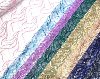 May include: A collection of shimmering lace fabrics in various colors, including pink, blue, purple, green, gold, and navy. Each fabric features a delicate, flowing pattern with glitter accents, creating a textured and elegant appearance. Ideal for crafting and design projects.