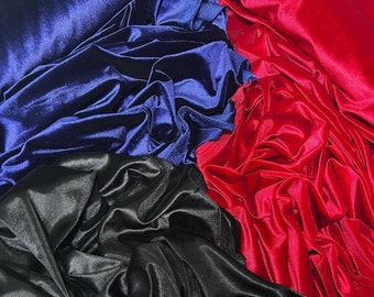 May include: Three pieces of fabric in different colors: dark blue, black, and red. The fabric is velvet and has a soft, luxurious feel.