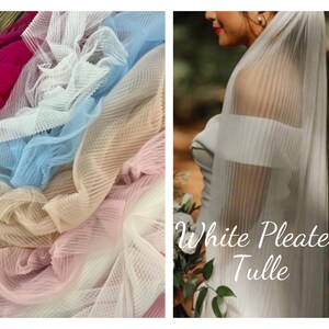 May include: A close-up of white pleated tulle fabric. The fabric is soft and delicate, and it has a beautiful, flowing drape. The fabric is perfect for making wedding veils, dresses, and other special occasion garments.  White Pleated Tulle.