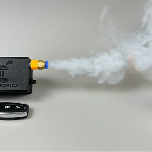 small 3dprinted plastic case that houses electronics to make a miniature sized smoke machine triggered via remote control.