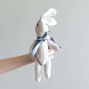 bunny-shaped plush toy with blue bow and red bell. Made to order. image 1