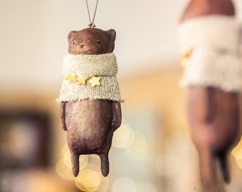 Vintage inspired hanging decoration in spun cotton. Brown and gold antique effect bear with gold wool sweater