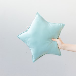 almohada en forma de estrella verde acqua