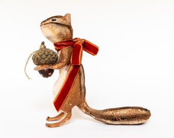 Japanese squirrel with acorn, squirrel decoration with bow and decorated acorn, artistic animal figurine in cotton wool.