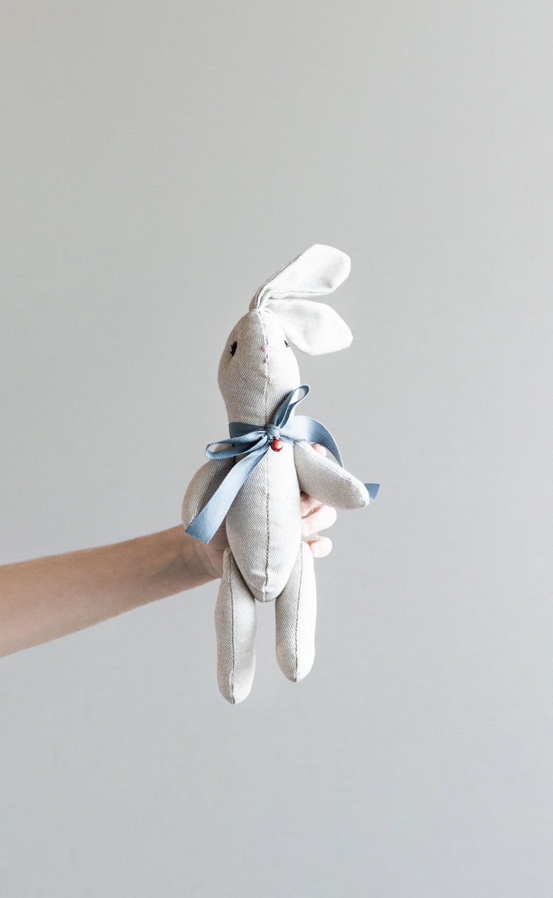 bunny-shaped plush toy with blue bow and red bell. Made to order. image 1