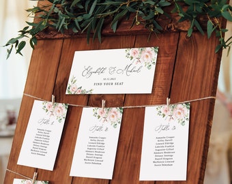 May include: A rustic wooden seating chart with a floral design. The chart is decorated with greenery and has a sign that says "Elizabeth & Michael" and "Find Your Seat".