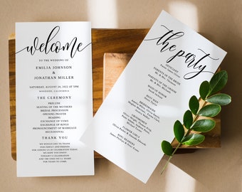May include: Two white wedding programs with black calligraphy text, one reading "welcome" and the other "the party." The programs are on a wooden surface with a sprig of green leaves.