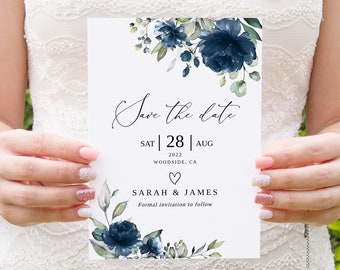May include: Save the date card with blue watercolor floral design. The card says "Save the date" with the date "SAT | 28 | AUG 2022" and the location "WOODSIDE, CA". The names "SARAH & JAMES" are printed below the date with the text "Formal invitation to follow".